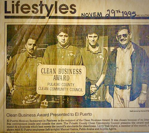 Newspaper clipping of four men holding a 