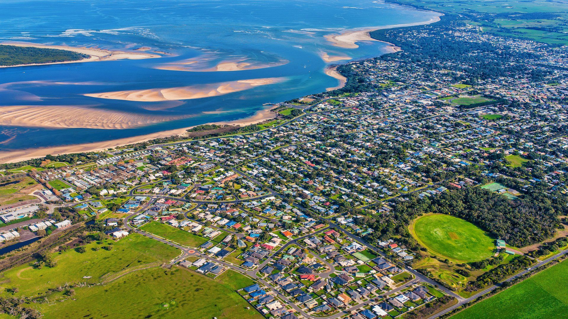 An aerial view of a city next to a body of water.