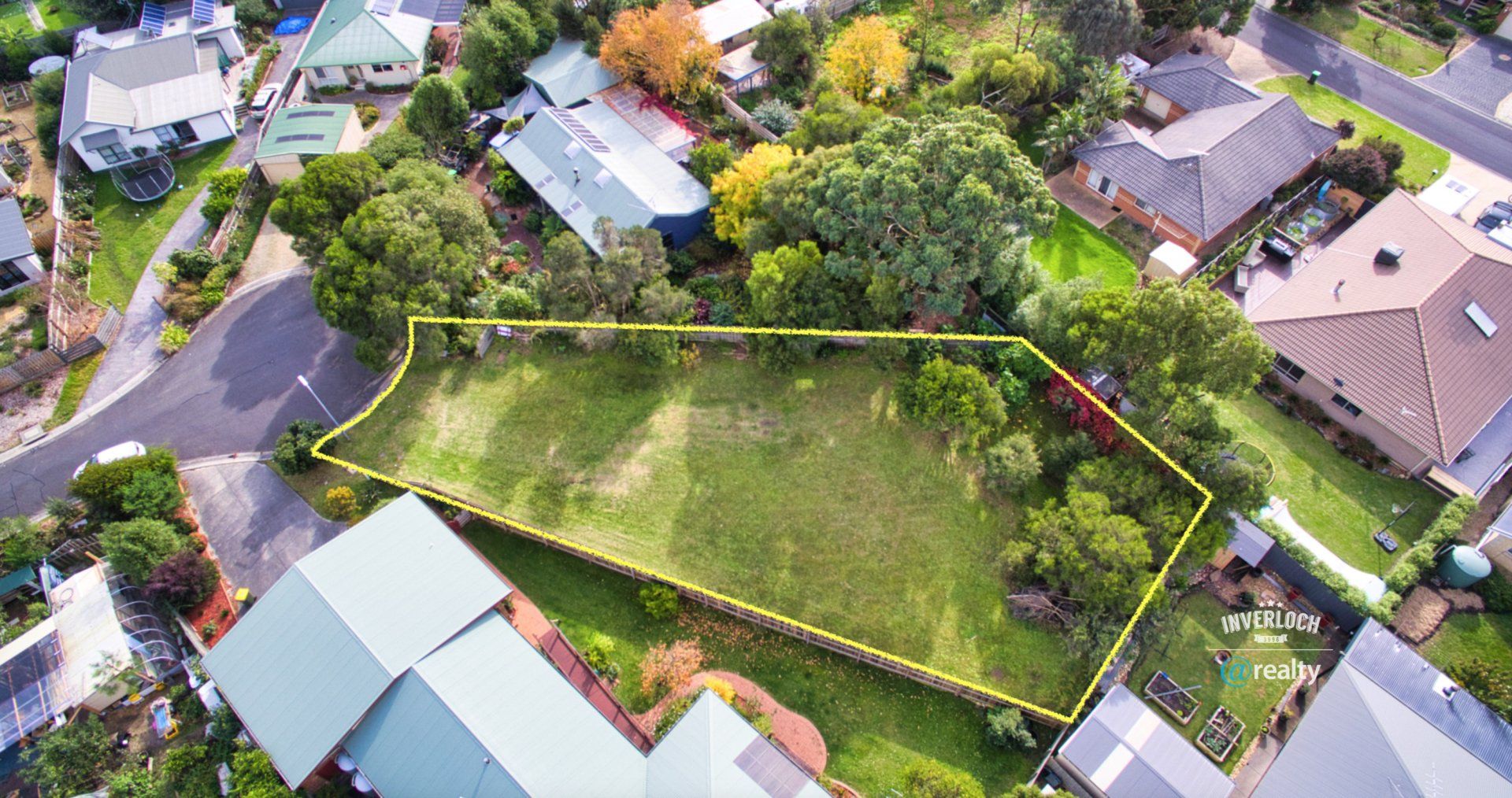 An aerial view of a residential area with houses and trees