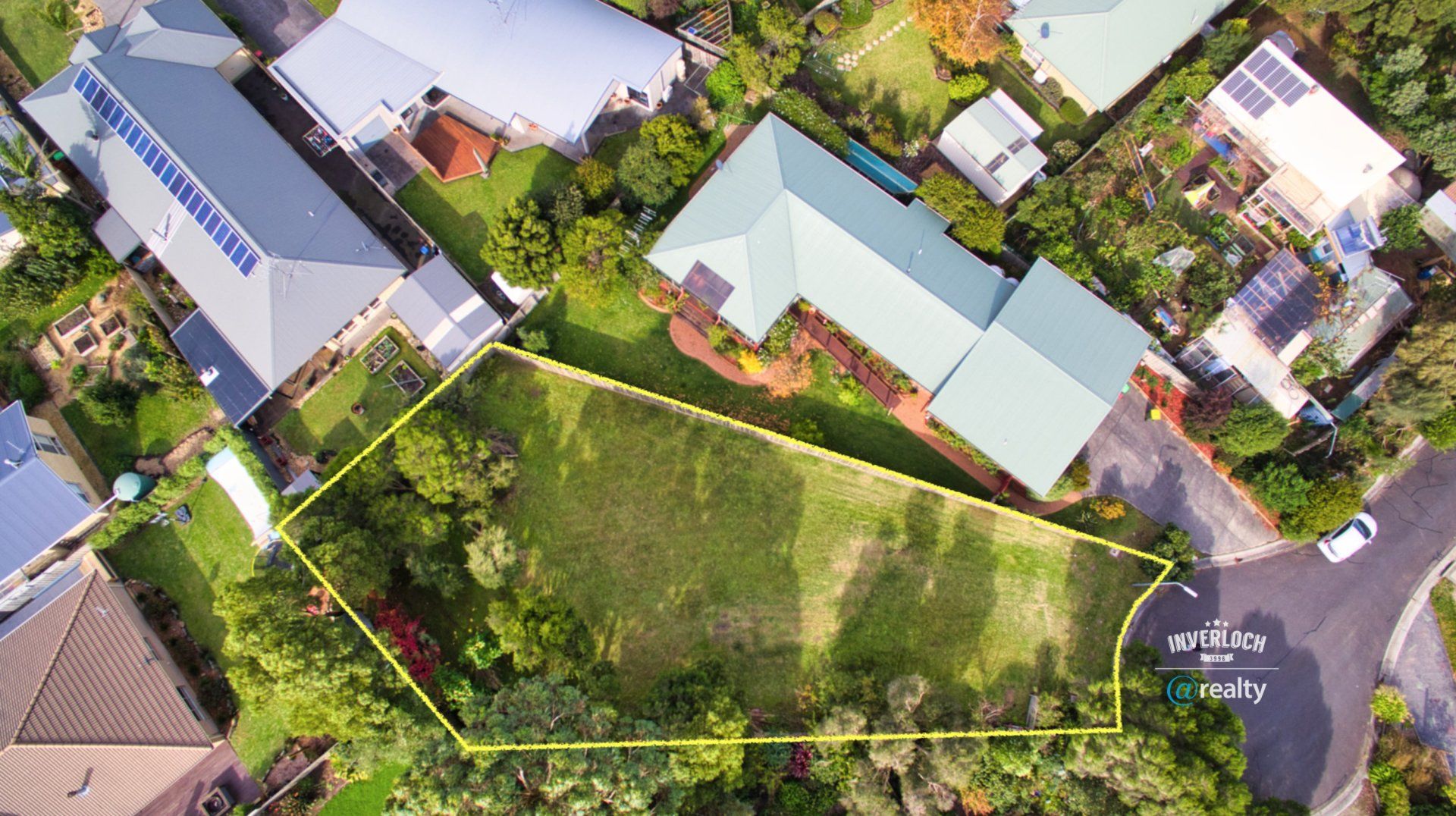 An aerial view of a residential area with houses and trees