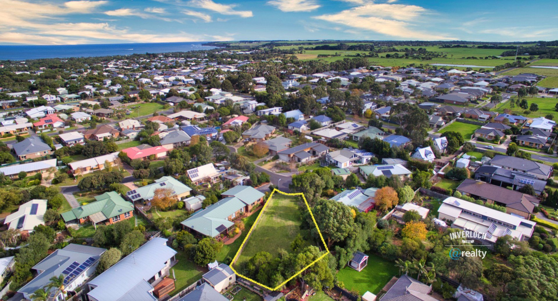 An aerial view of a residential area with lots of houses and trees.