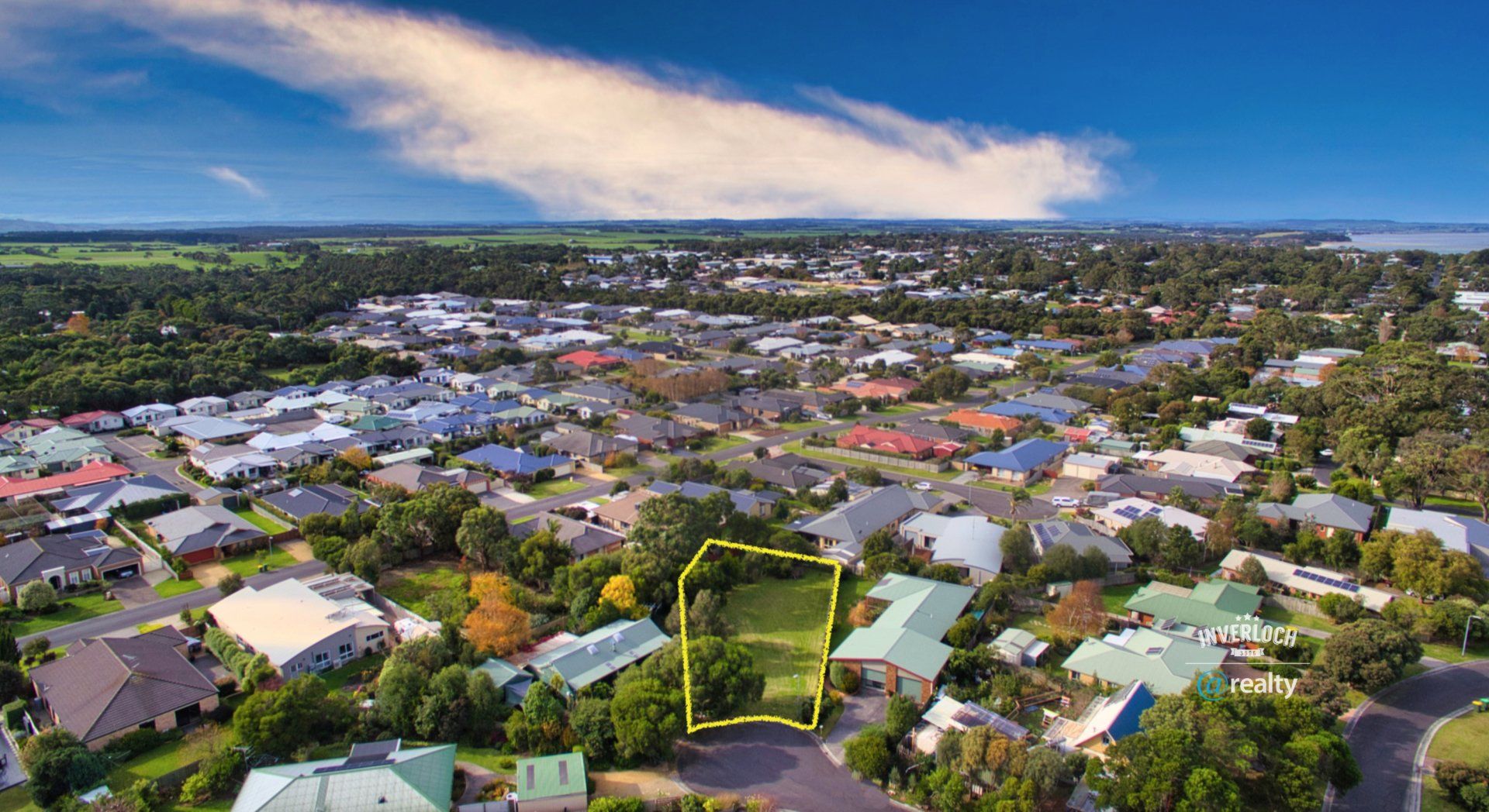 An aerial view of a residential area with lots of houses and trees.