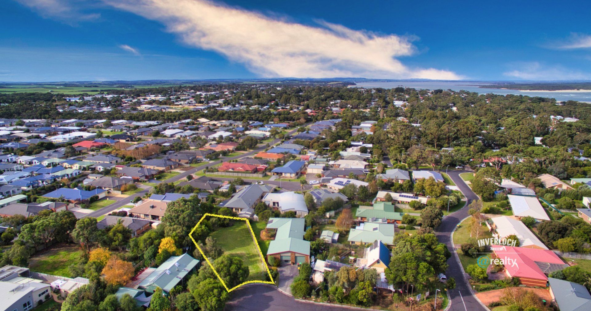An aerial view of a residential area with lots of houses and trees.