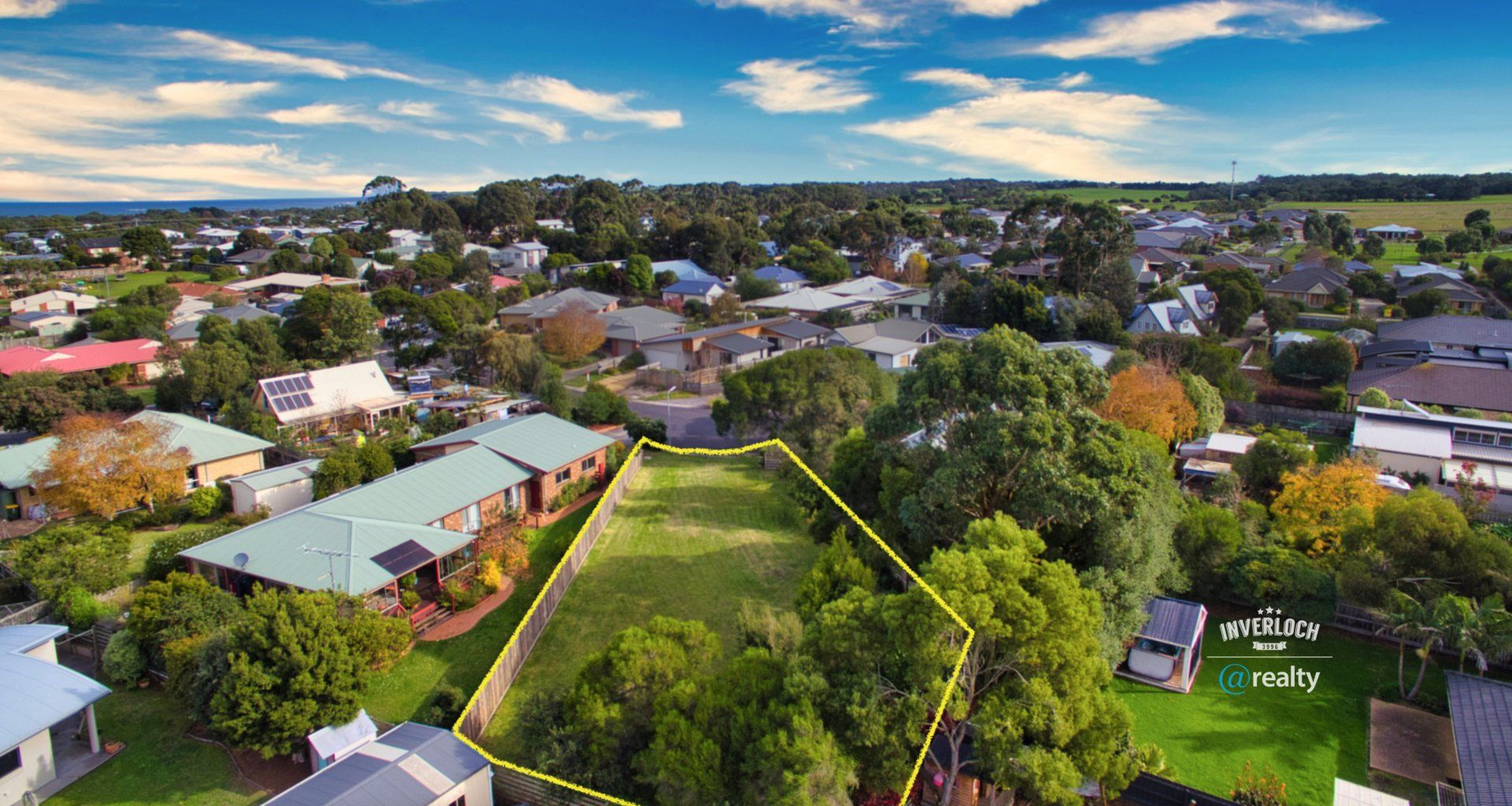 An aerial view of a residential area with houses and trees.
