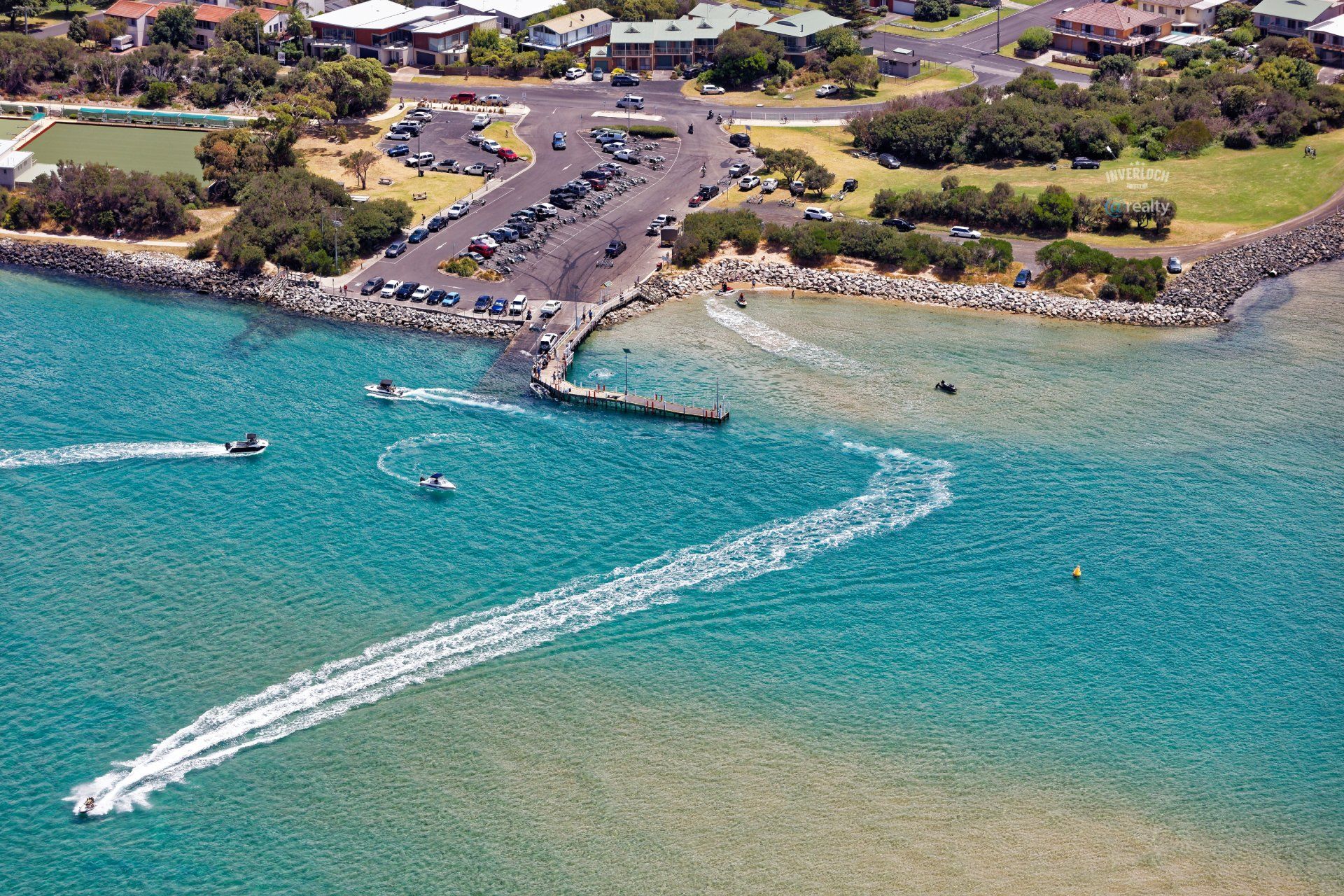 An aerial view of a body of water with boats in it