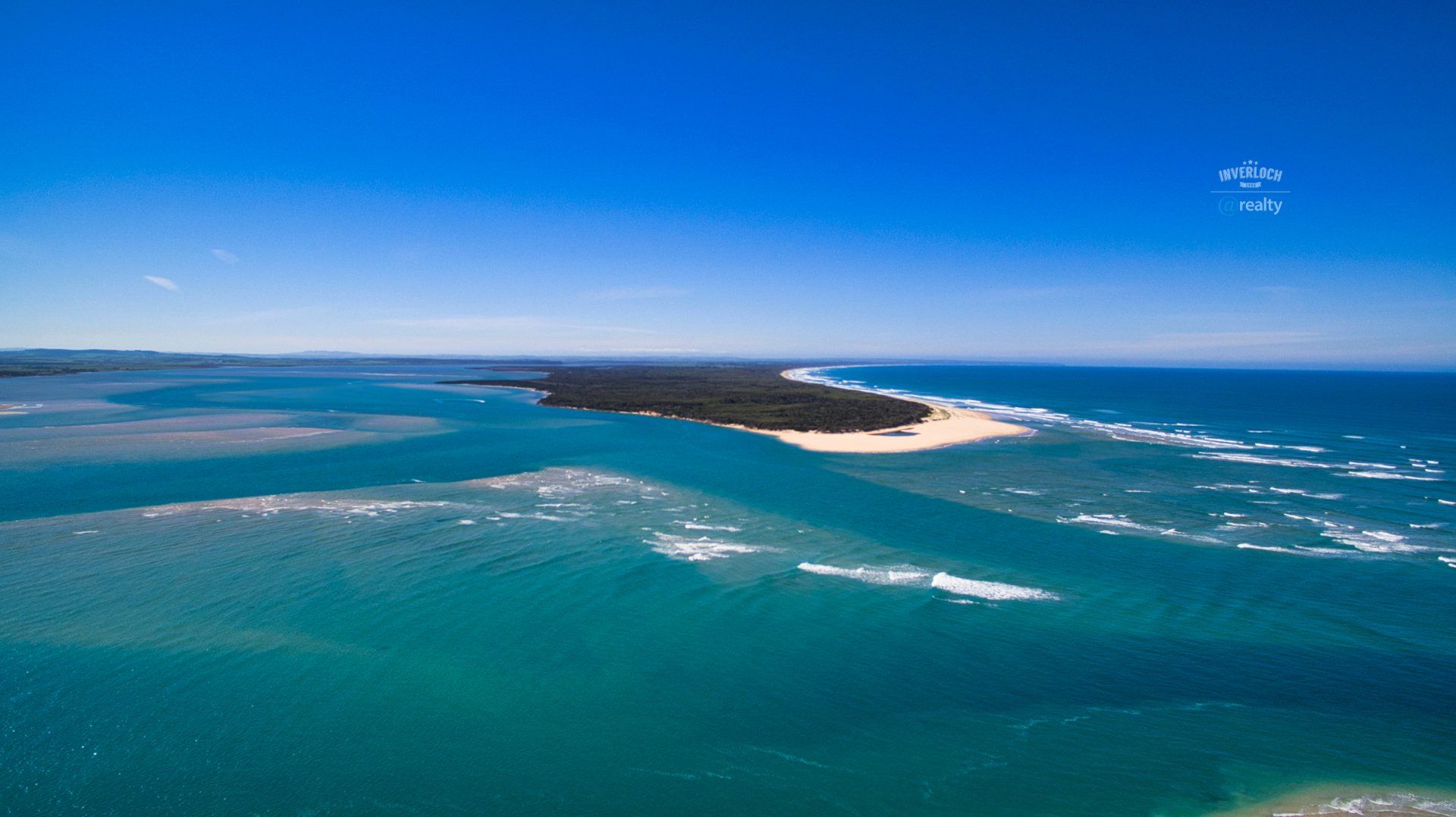 An aerial view of a small island in the middle of the ocean.