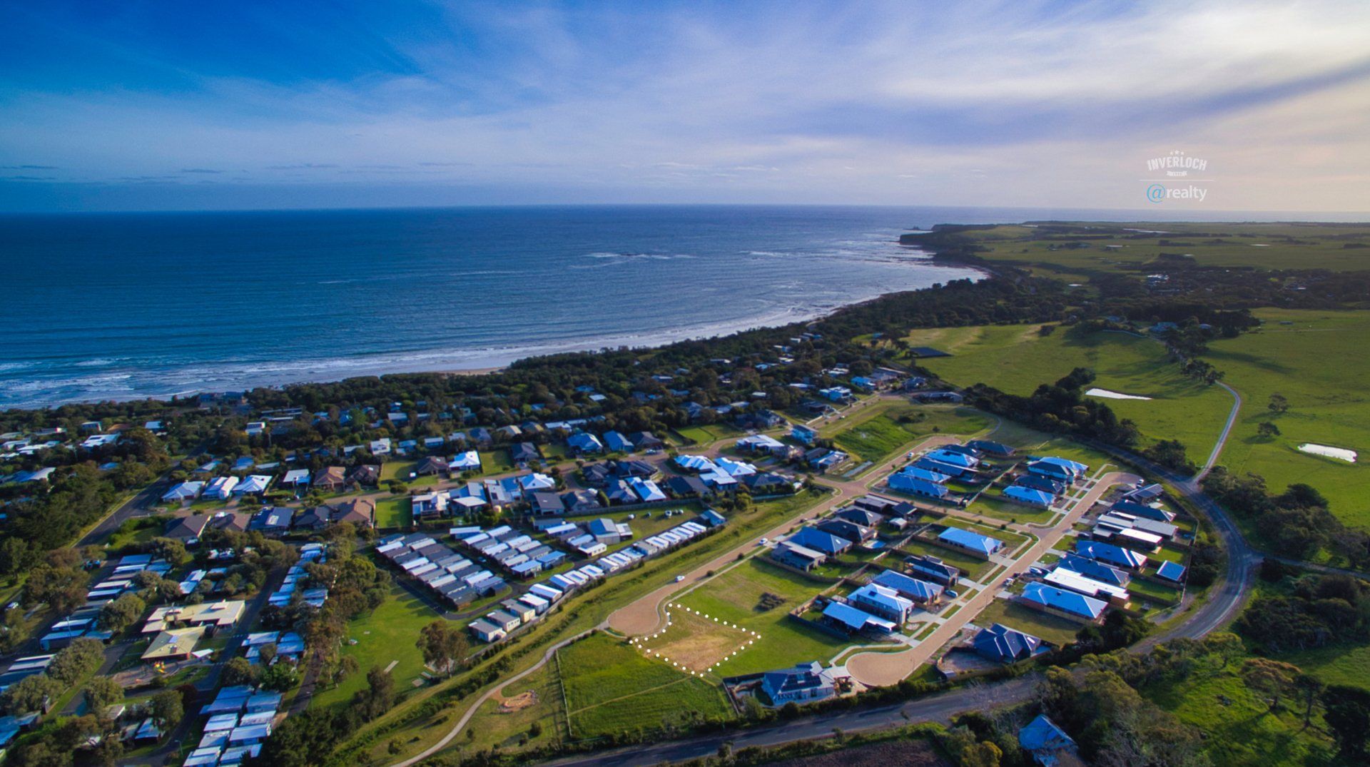 An aerial view of a residential area next to the ocean.