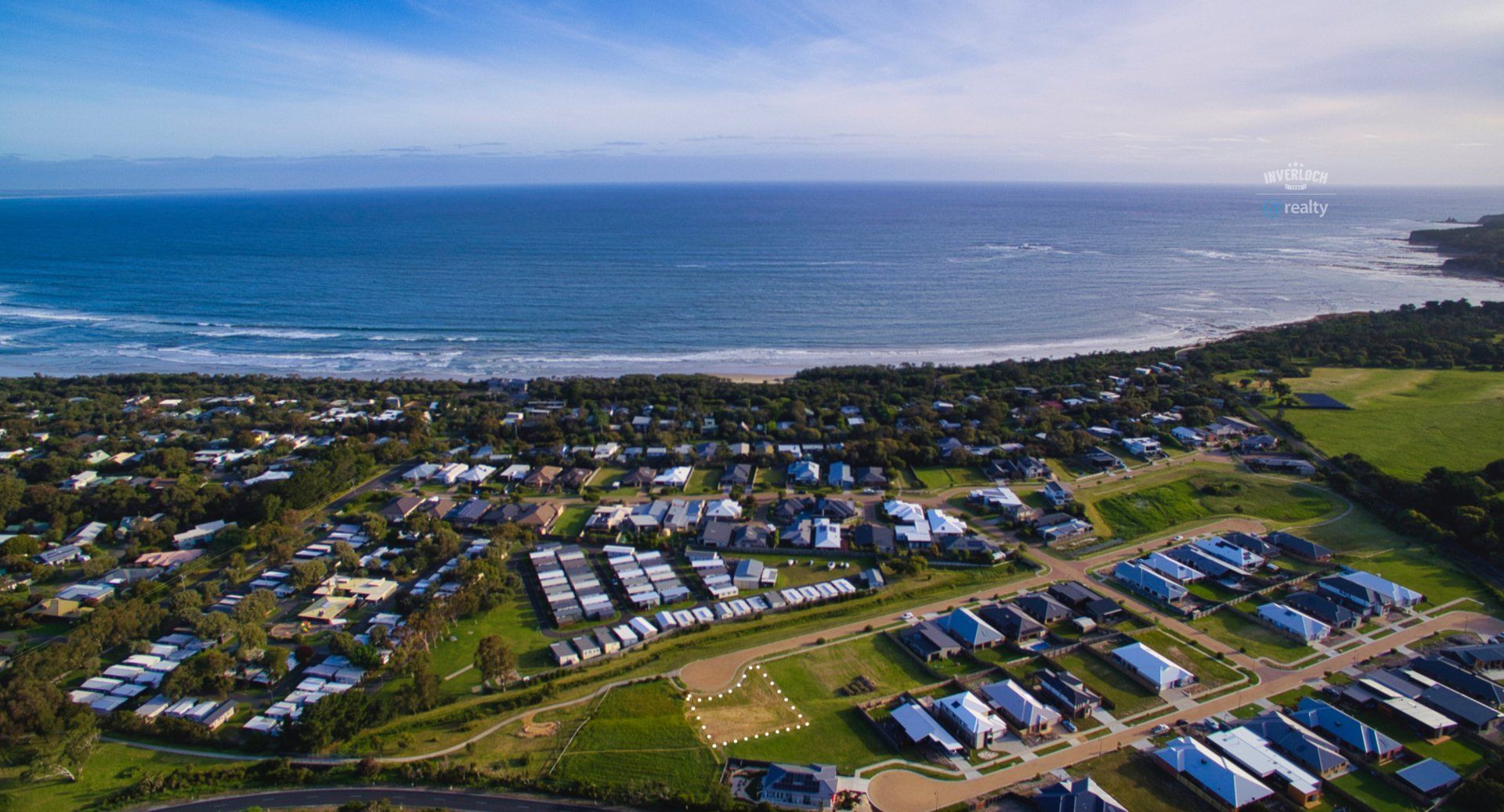 An aerial view of a residential area next to the ocean.