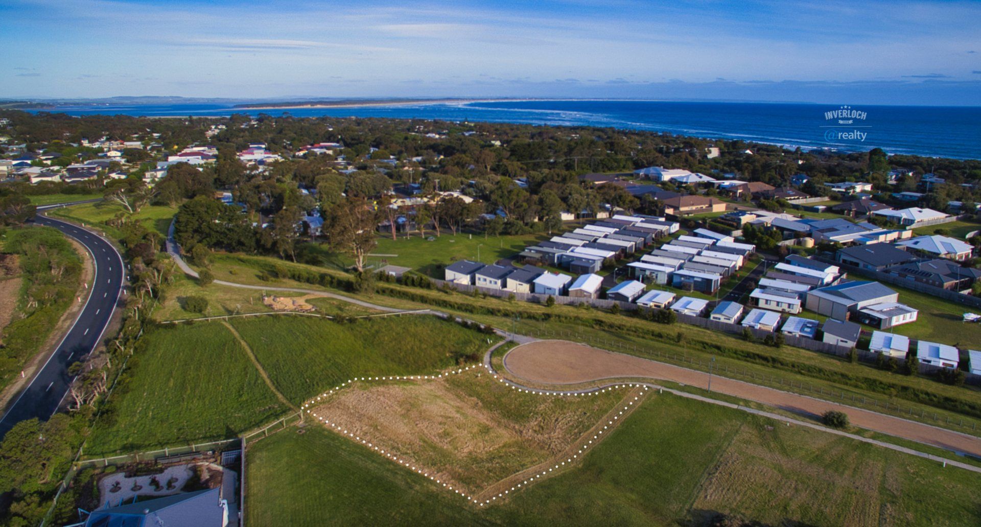 An aerial view of a residential area next to the ocean.