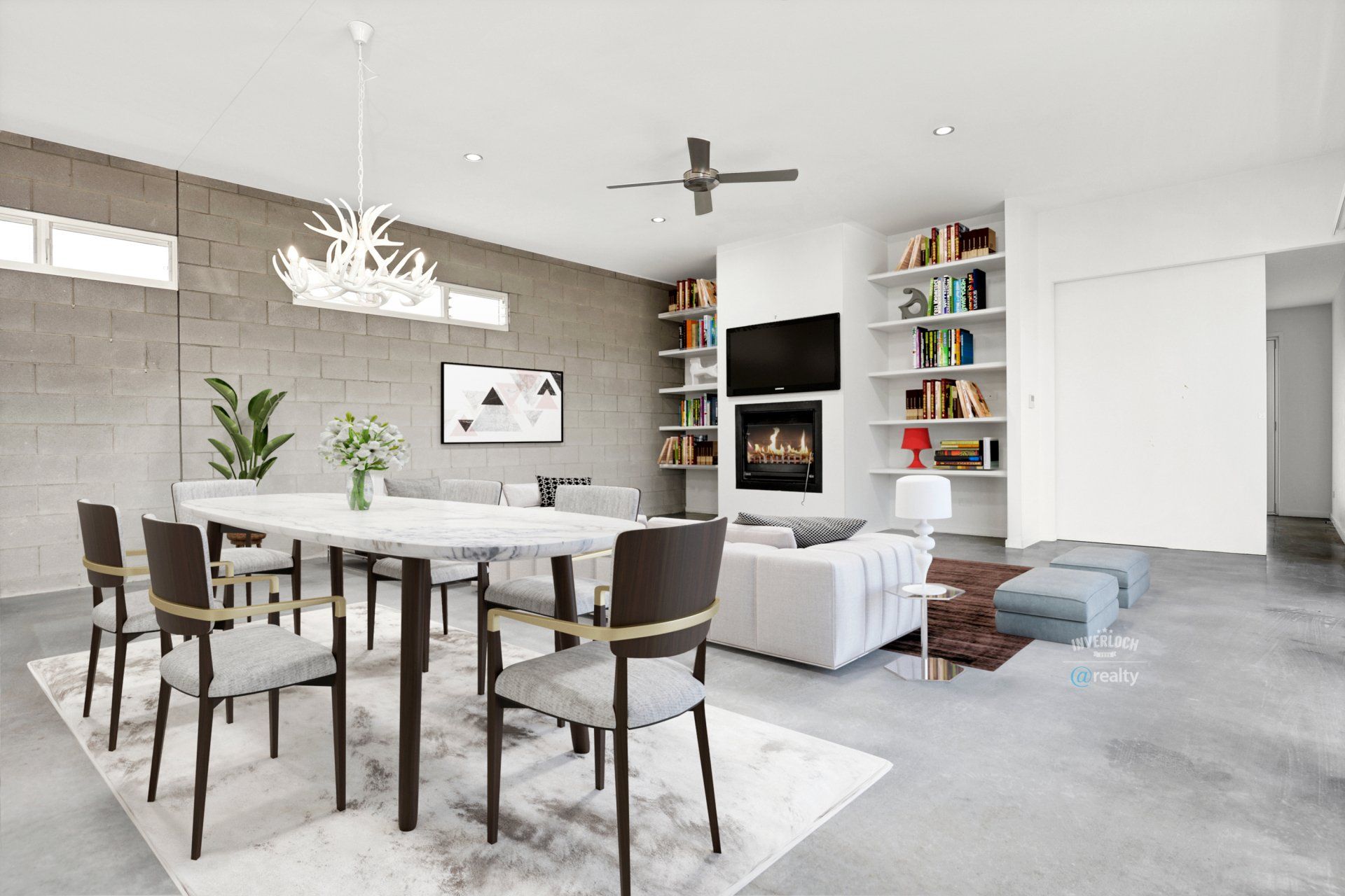 A living room with a dining table and chairs and a fireplace.