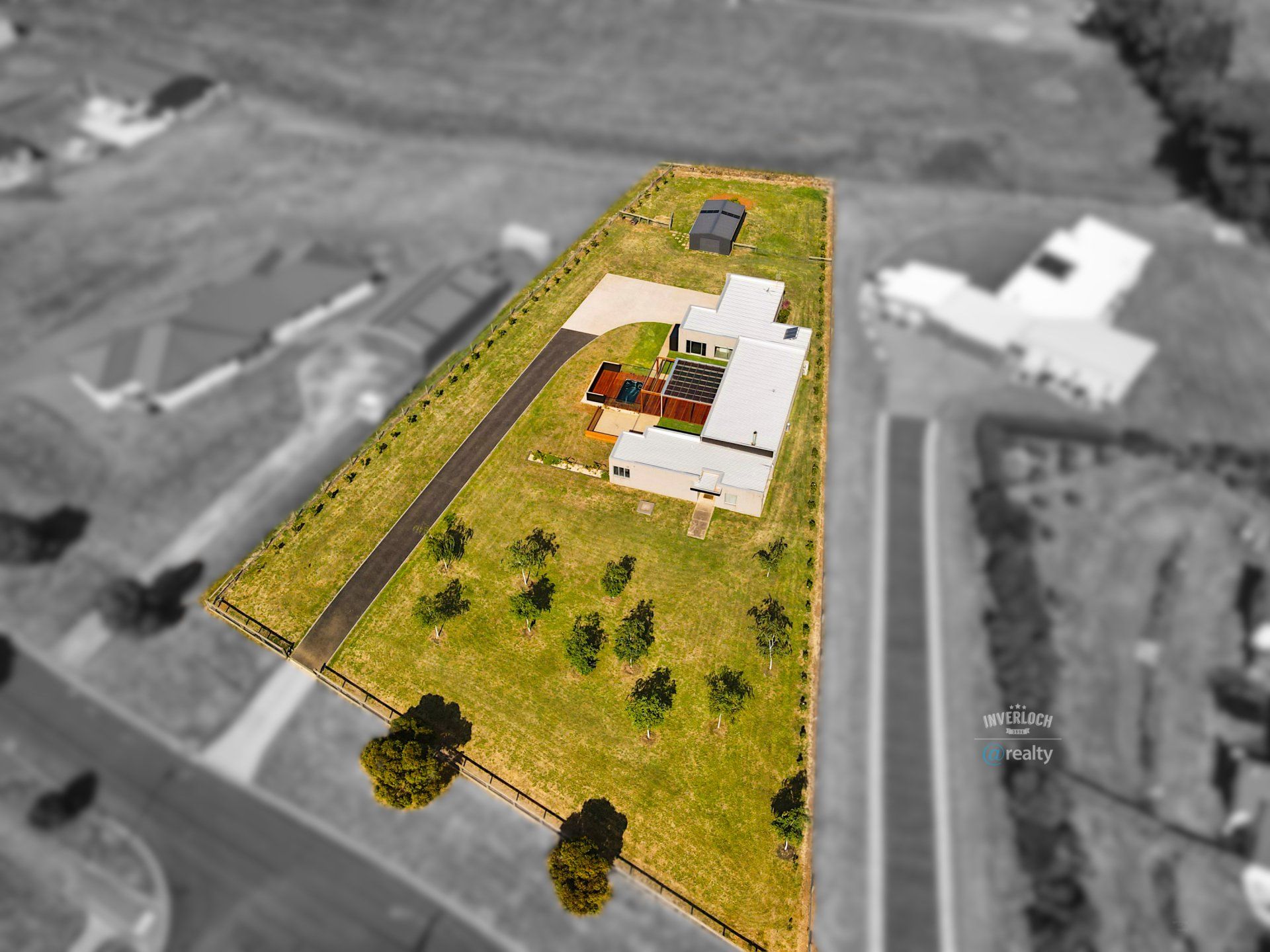 An aerial view of a large residential area with a house in the middle.