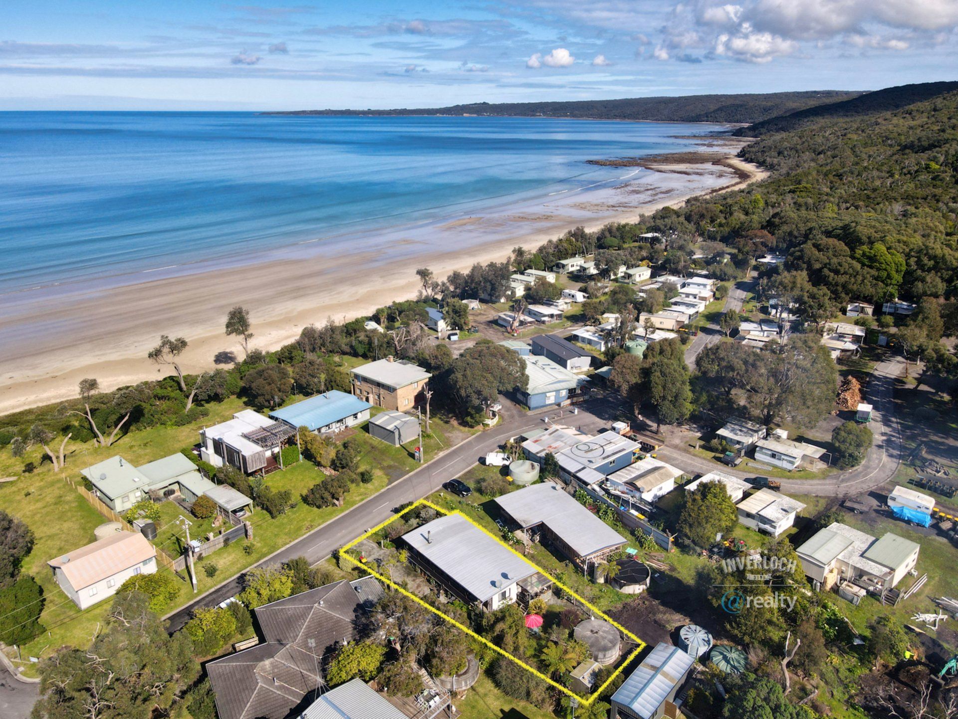 An aerial view of a residential area next to a beach.