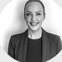 A woman is smiling in a black and white photo.