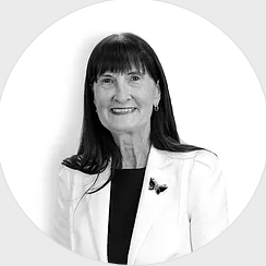 A black and white photo of a woman wearing a white jacket and a black shirt.