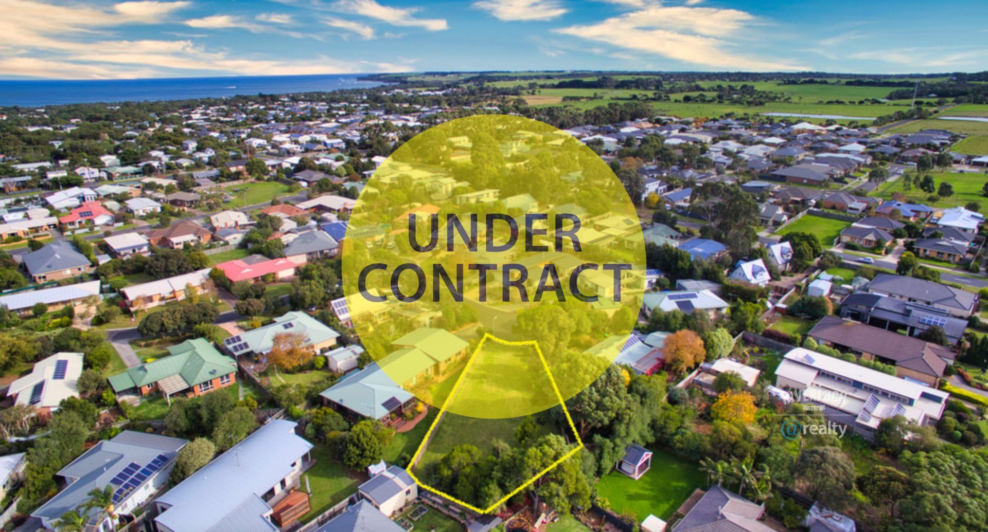 An aerial view of a residential area with a yellow circle that says `` under contract ''.