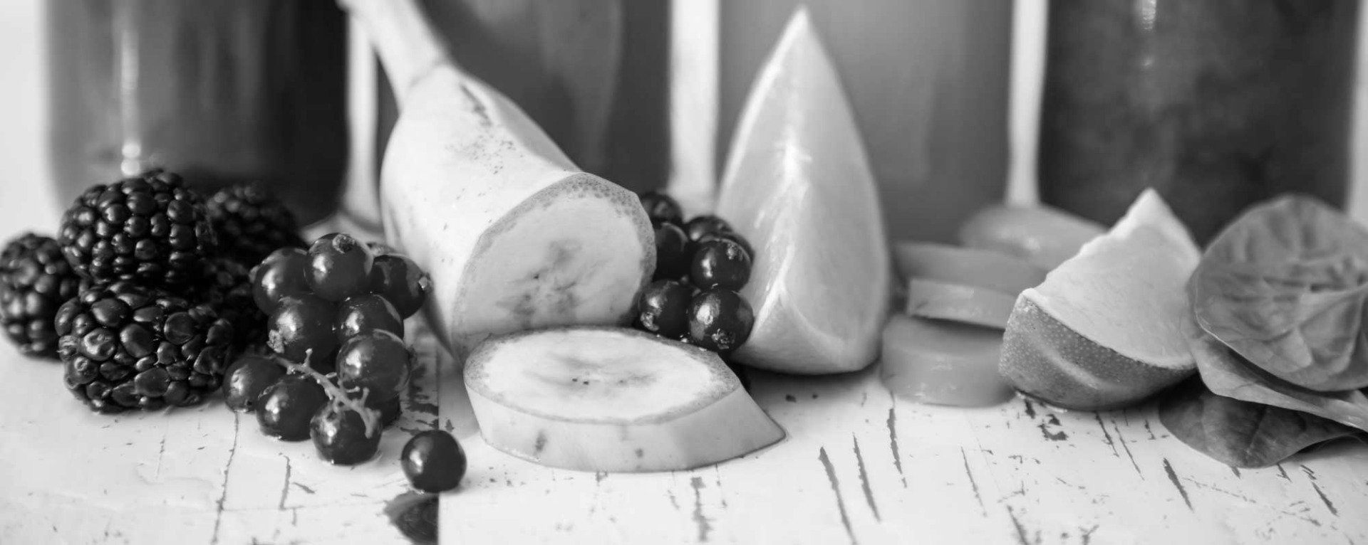 A black and white photo of fruits and vegetables on a table.