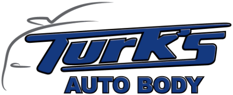 Turk's Auto Body logo in blue and silver text on a white background