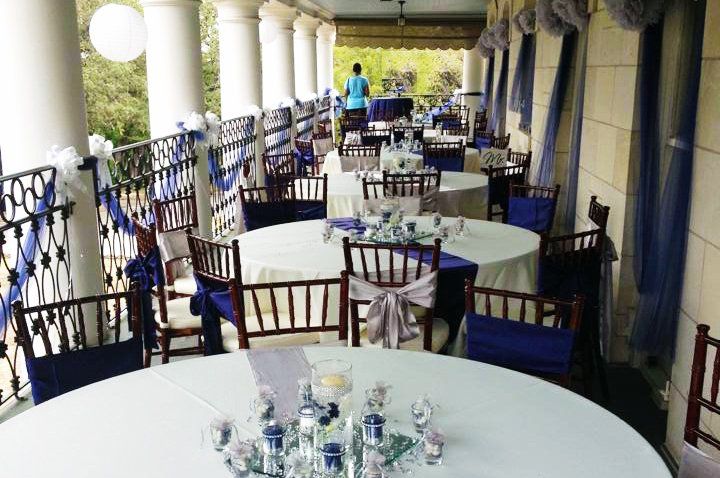 a dining room with tables and chairs set up for a wedding reception .