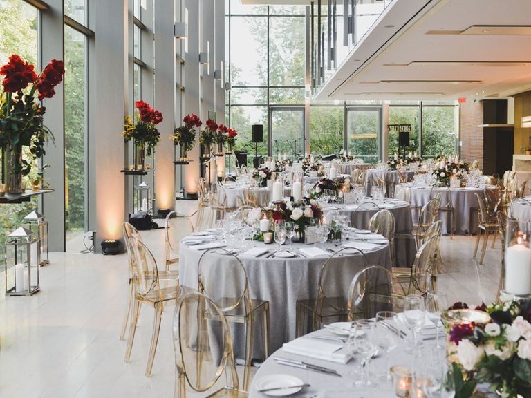 a large room with tables and chairs set up for a wedding reception .