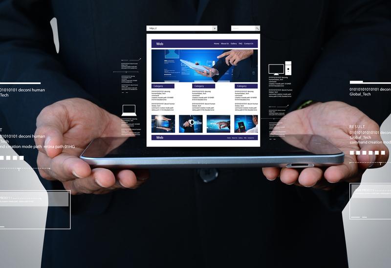 two hands presenting an open laptop with a website onscreen