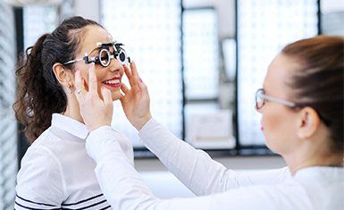 Comprehensive Eye Examination — Woman Fitting Eyeglasses in Danville, KY Comprehensive Eye Examination — Woman Fitting Eyeglasses in Danville, KY