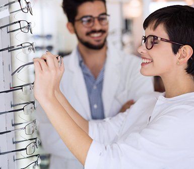 Eyeglass Frames — Woman Trying On Eyeglasses in Danville, KY Eyeglass Frames — Woman Trying On Eyeglasses in Danville, KY