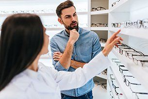 Optical Shop — Man Looking at Eyeglasses in Danville, KY