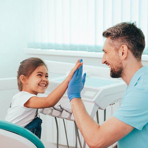 A Child and a Dentist High Five — Hickory, NC — McDonald Family Dentistry A Child and a Dentist High Five — Hickory, NC — McDonald Family Dentistry