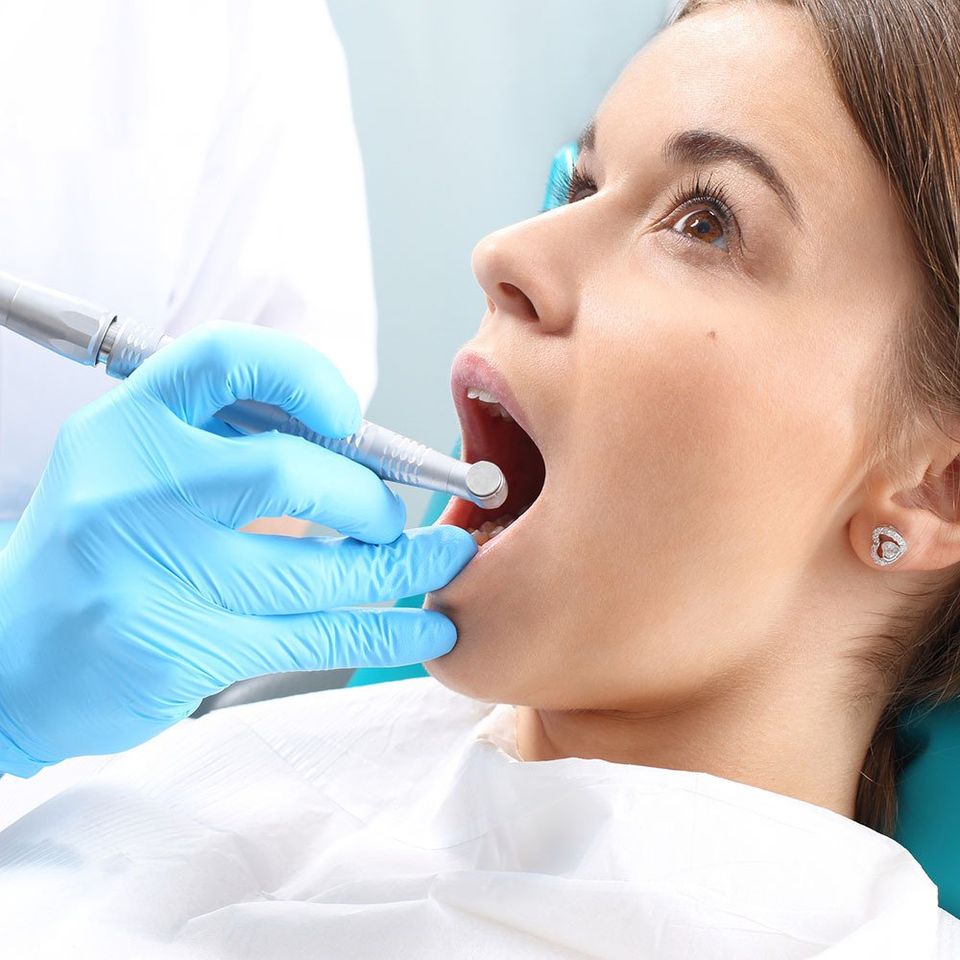 Dentist Checking the Teeth of a Woman — Hickory, NC — McDonald Family Dentistry Dentist Checking the Teeth of a Woman — Hickory, NC — McDonald Family Dentistry