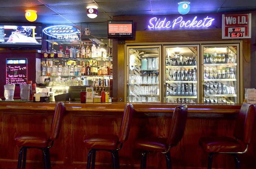 Interior photo of Side Pockets Lenexa with a neon sign that says side pockets