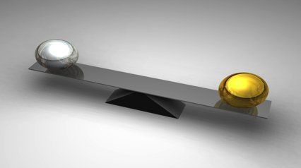 Balancing 2 balls on a set of scales showing balance