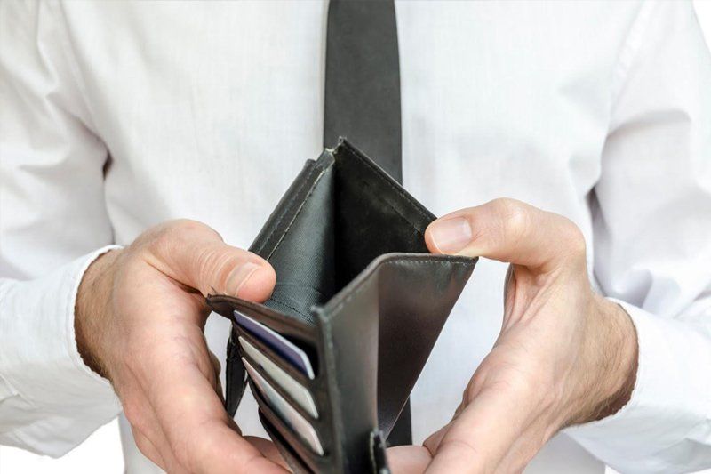 Man Showing Empty Wallet — Livonia, MI — Charles J Schneider PC Man Showing Empty Wallet — Livonia, MI — Charles J Schneider PC