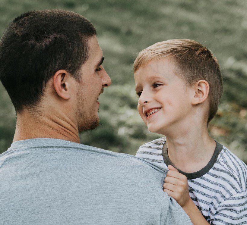 Father holding son. Return to work and career break online seminars.