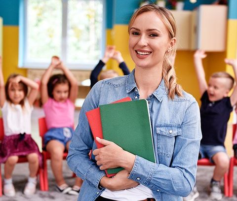 Smiling Female Teacher in the Preschool — Benton County Health Department — Warsaw, MO