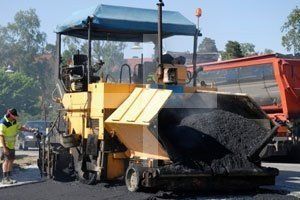 Asphalt paving contractors fixing road in Buffalo, NY