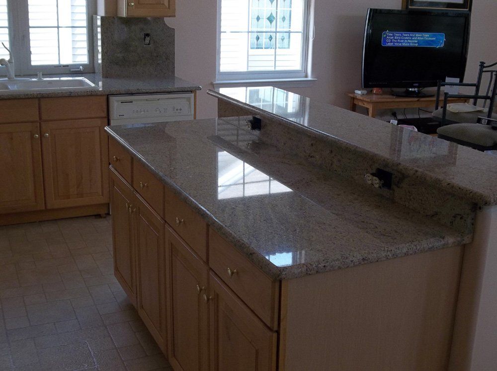 Granite kitchen island installation with raised seating