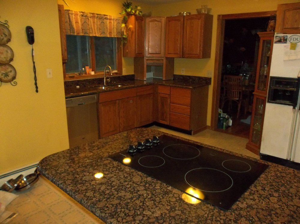Granite kitchen countertop installation in warm wood kitchen
