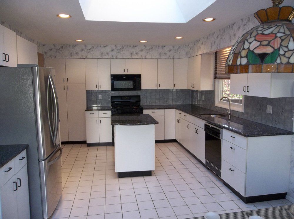 Installed granite kitchen countertops in white kitchen