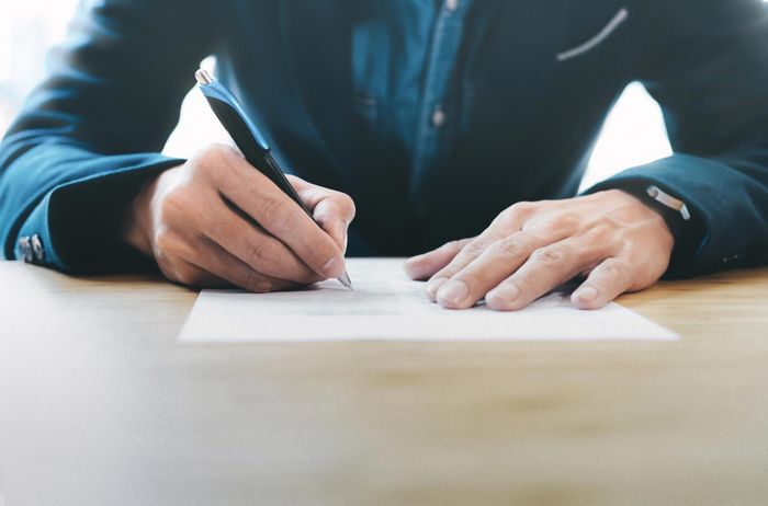 Man Signing a Document — Pensacola, FL — Mary Ann Patti LLC Man Signing a Document — Pensacola, FL — Mary Ann Patti LLC