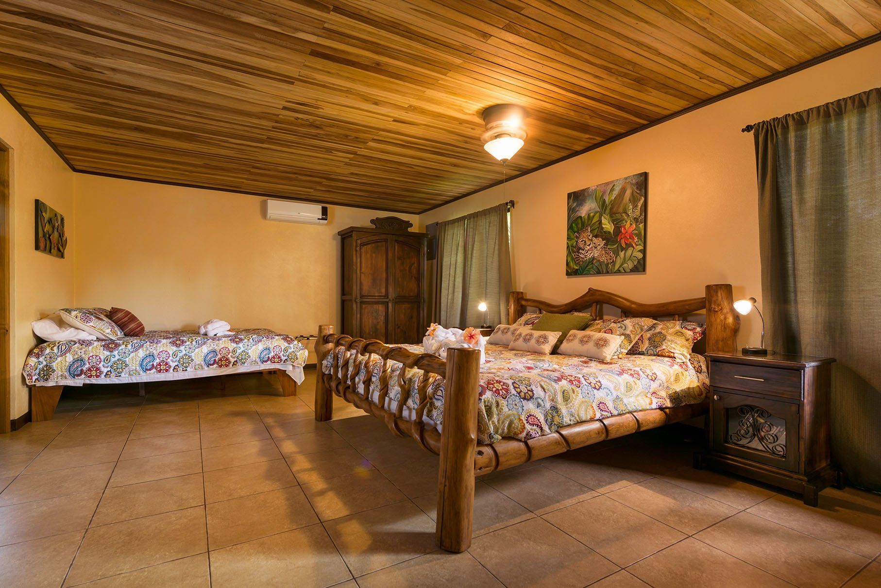a bed with a wooden headboard and pillows in a bedroom .