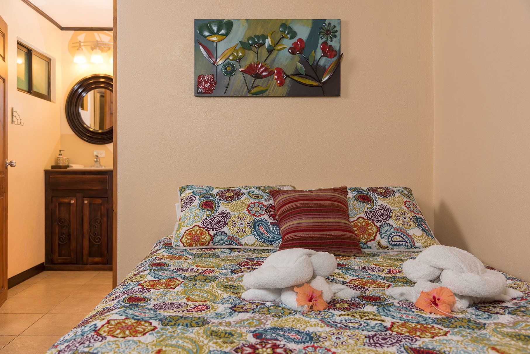 a bedroom with a bed and a painting on the wall .
