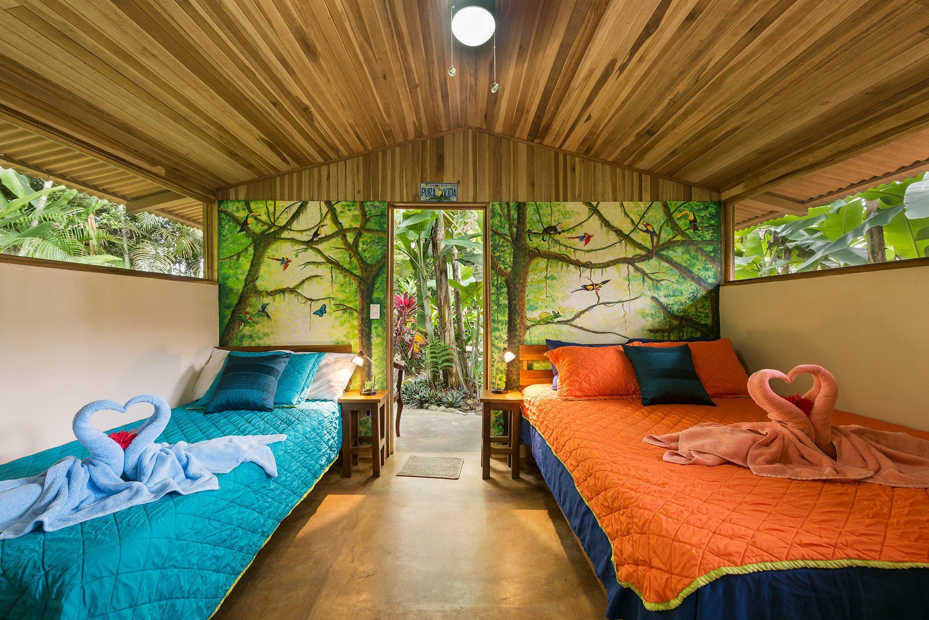 a bedroom with two beds and a painting on the wall .