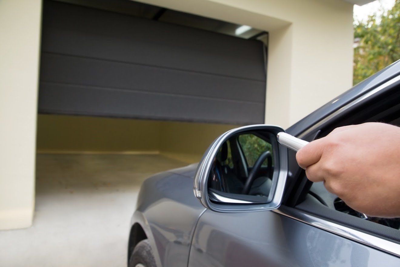 Driver opening a garage using a remote — Signal Hill, CA — Edgemont Garage Driver opening a garage using a remote — Signal Hill, CA — Edgemont Garage