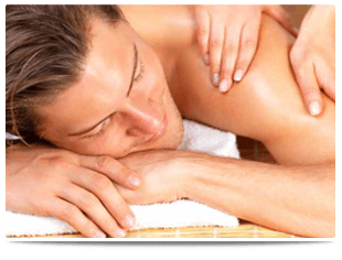 If you're looking for a stress relieving massage in Ballymoney call Papillon Beauty, Skincare & Relaxation A lady massaging a smiling man's shoulder