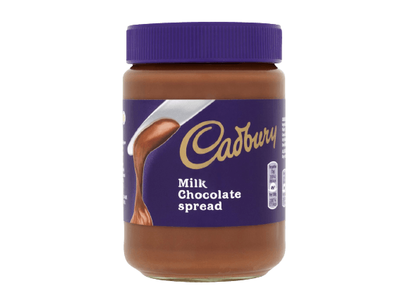 A jar of Cadbury Milk Chocolate spread with a purple lid and label featuring an illustration of chocolate being poured.