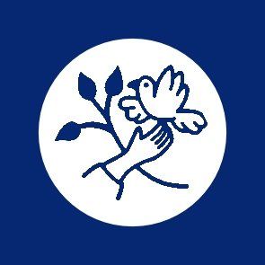 White dove held by hand, olive branch, inside white circle on blue background.