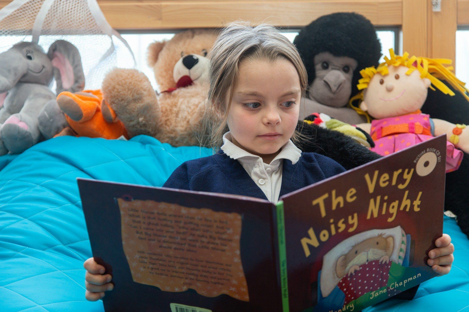 Girl reading a book titled