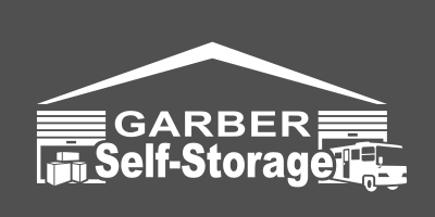 The logo for garber self storage shows a garage with a roof.