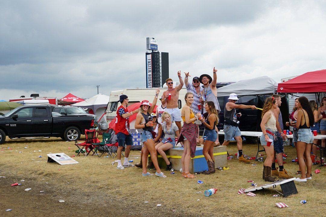 A group of people are standing in a field.