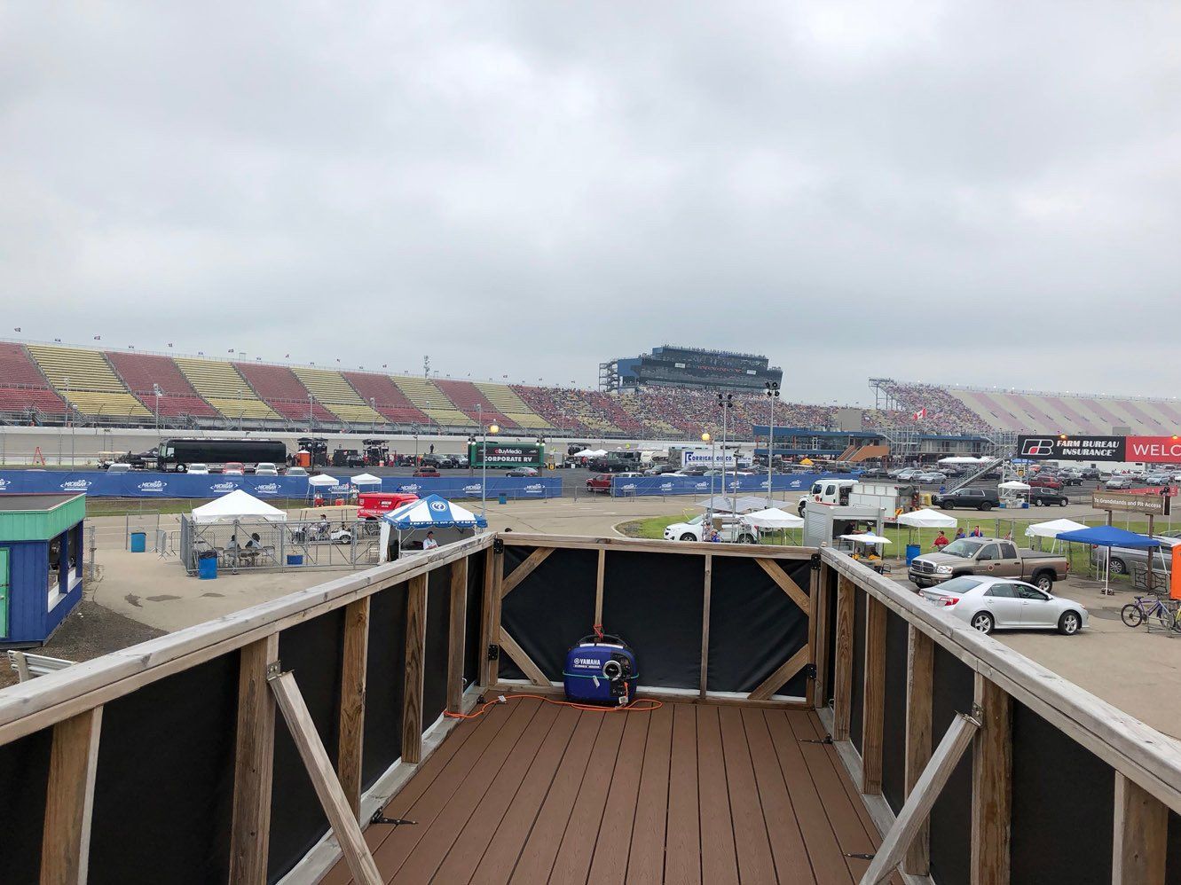 A view of a race track from a wooden deck